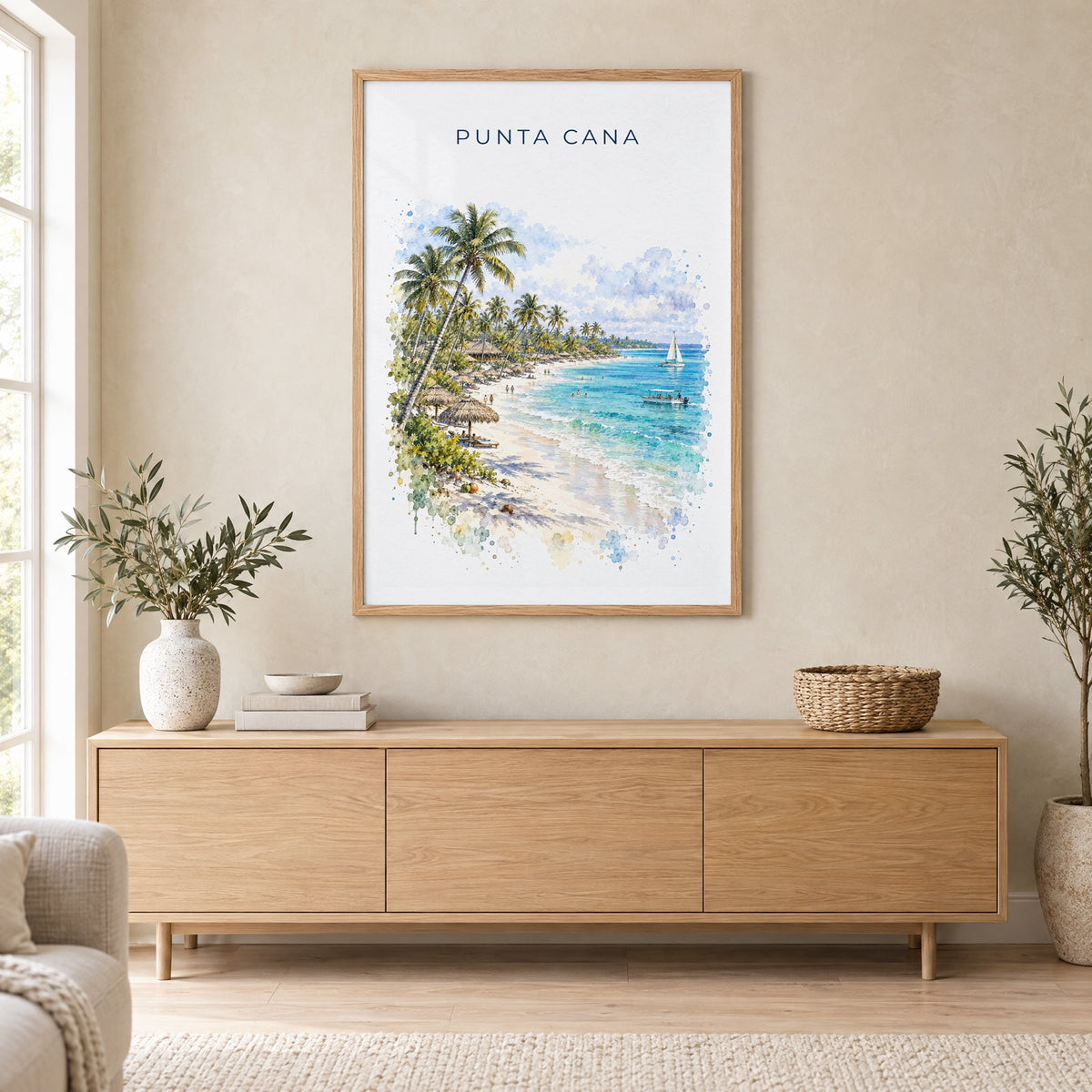 Punta Cana watercolor print in an oak frame above a light wood sideboard in a Scandinavian living room