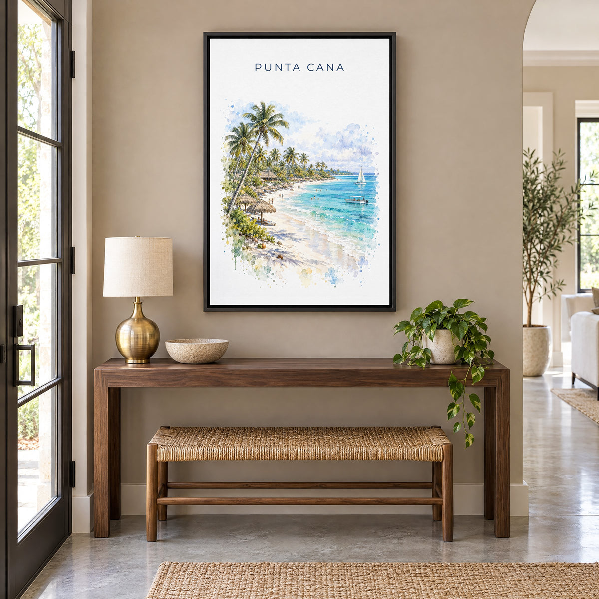 Punta Cana watercolor print as a black floater canvas above a walnut console and woven bench in an entryway