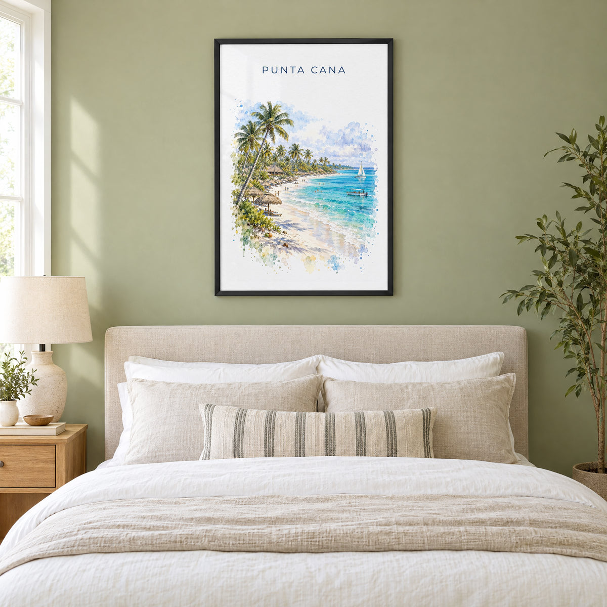 Punta Cana watercolor print in a black frame above an upholstered headboard in a sage green bedroom
