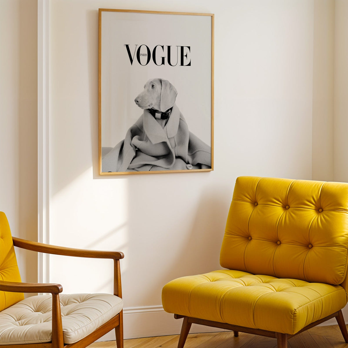 Puppy in oversized wool coat magazine cover print shown in a gold frame above a mustard yellow tufted armchair