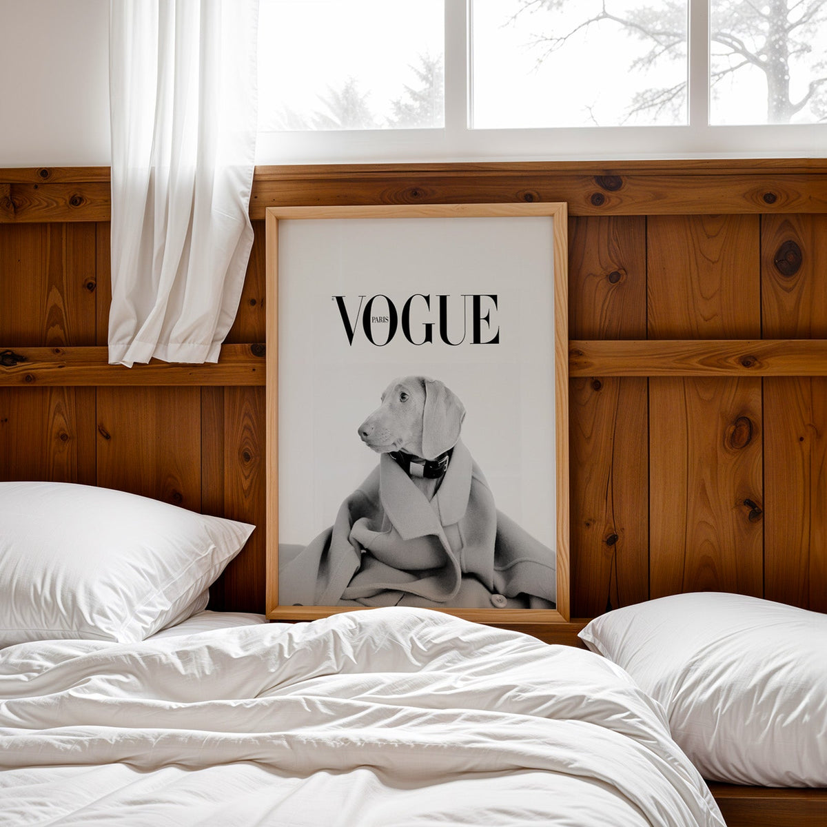 Puppy in oversized wool coat magazine cover print in a pine frame leaning on a wood headboard over white bedding