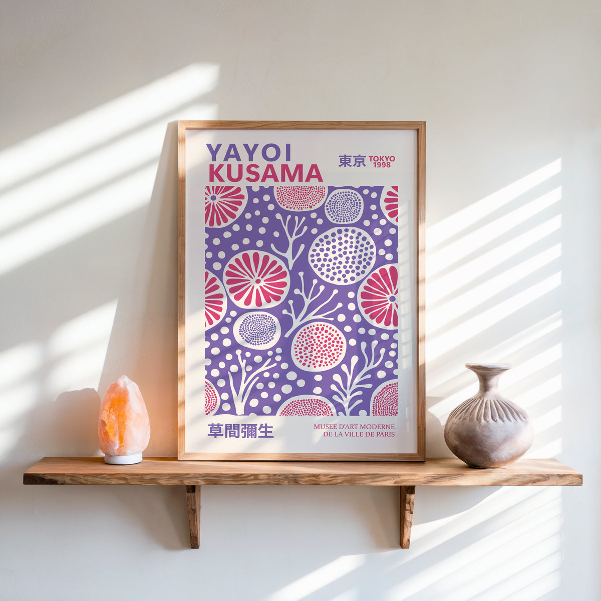 Yayoi Kusama inspired purple and pink floral dot print above a shelf with a salt lamp