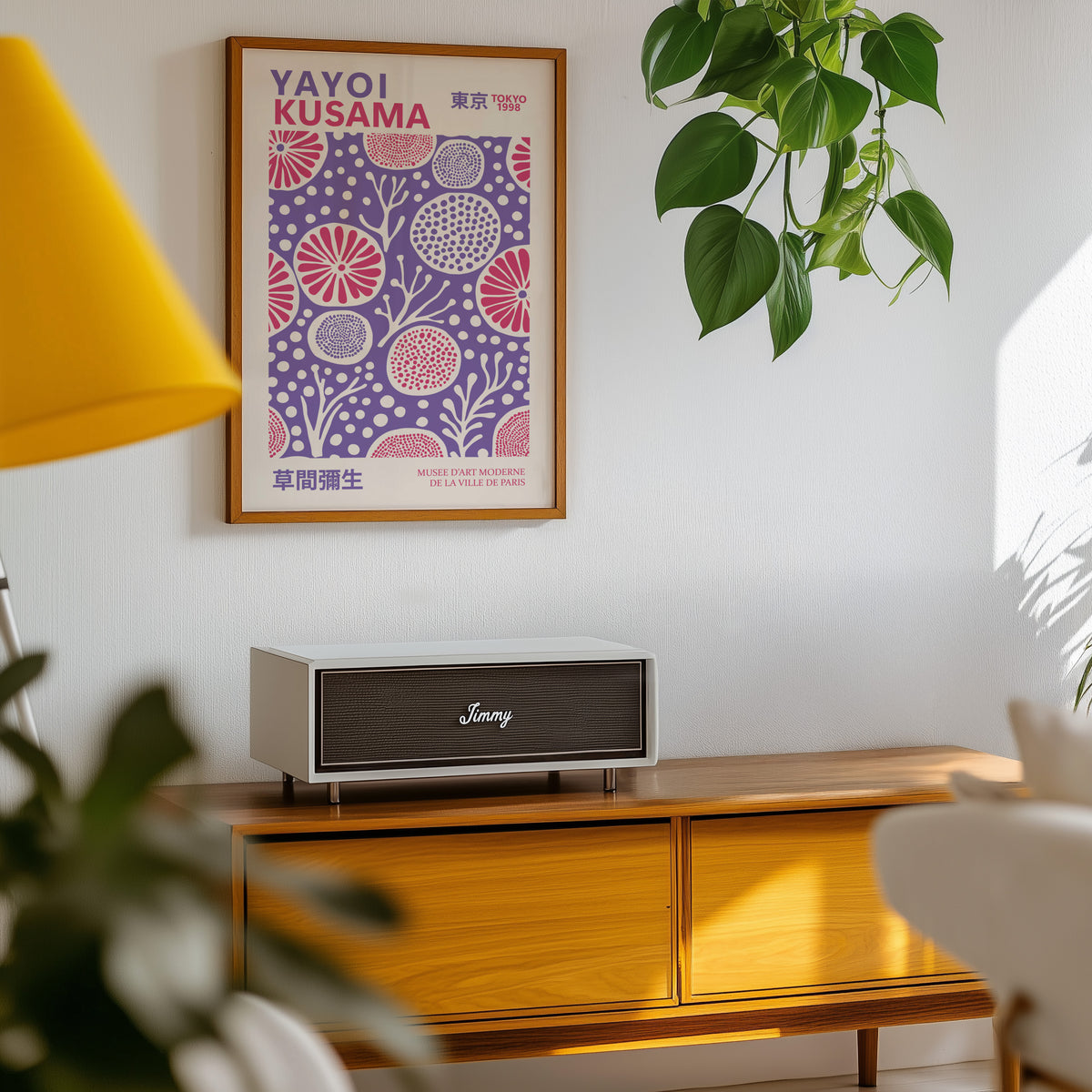 Yayoi Kusama inspired purple and pink floral dot print above a sideboard with a plant