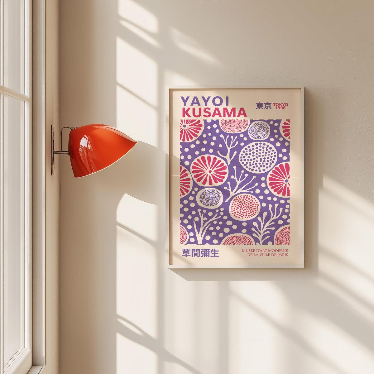 Yayoi Kusama inspired purple and pink floral dot print in a white frame by a red wall lamp
