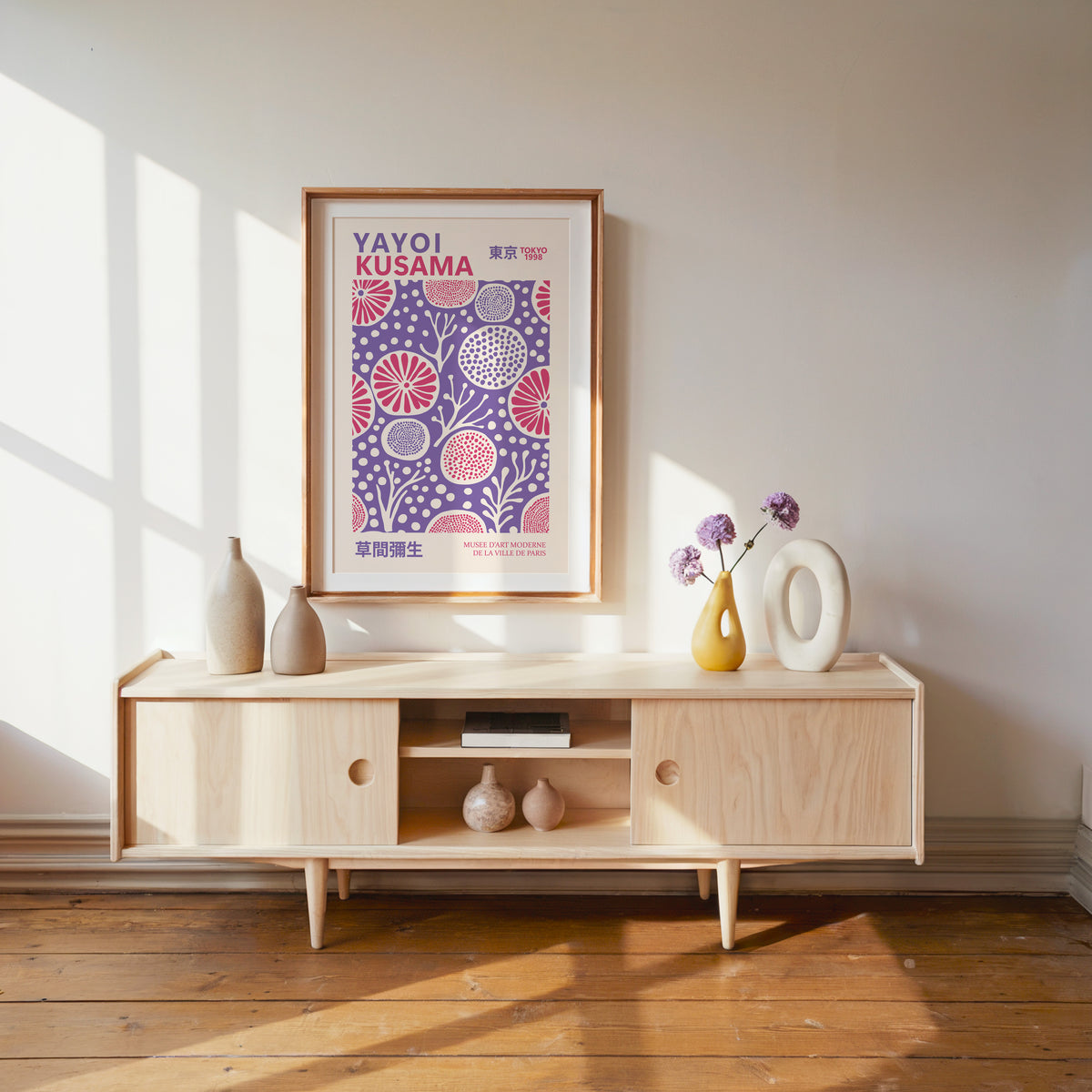 Yayoi Kusama inspired purple and pink floral dot print above a pale wood console