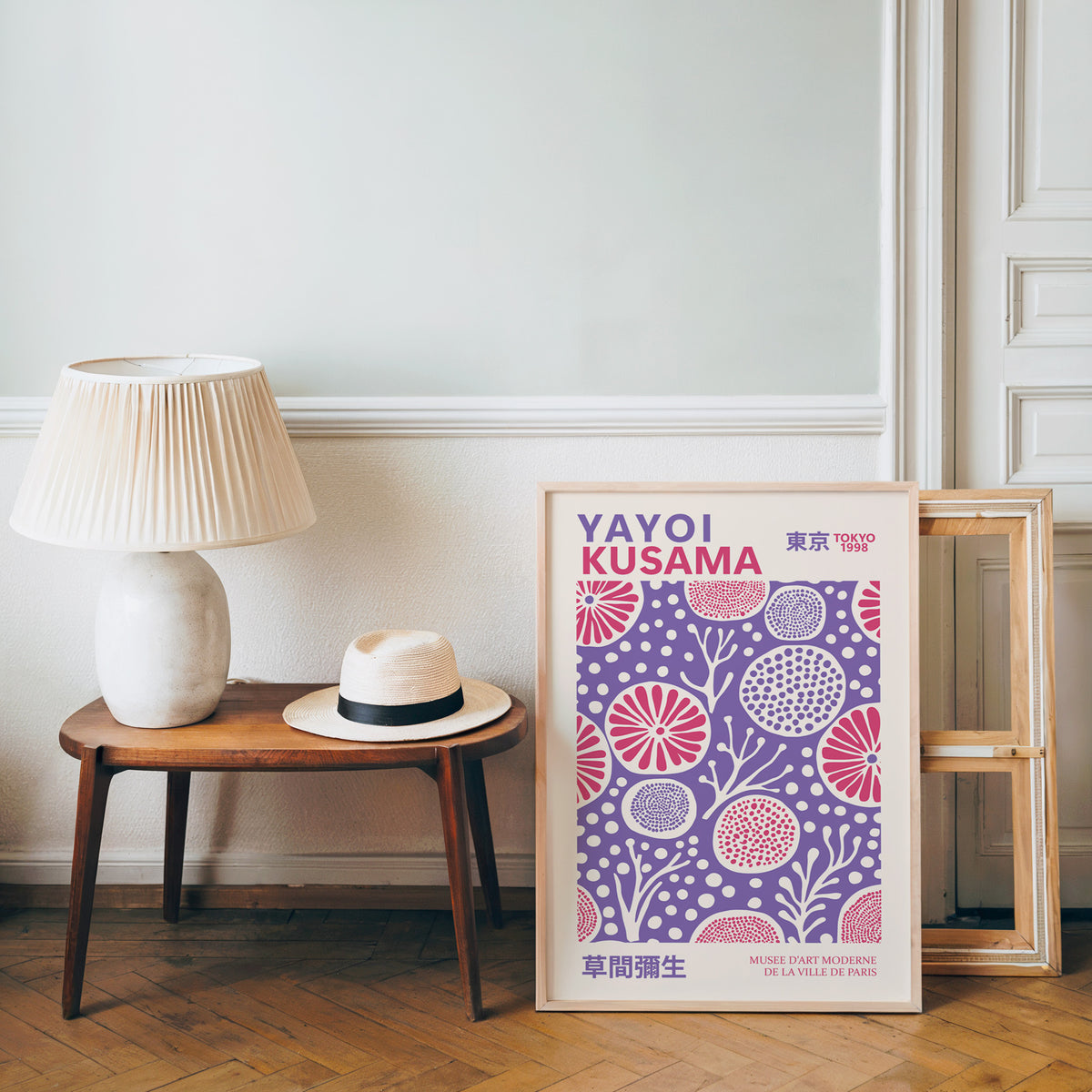 Yayoi Kusama inspired purple and pink floral dot print beside a bench and straw hat