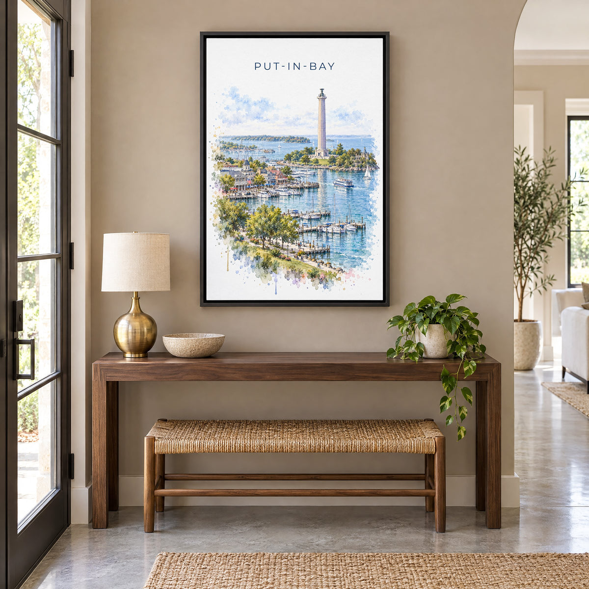 Put-in-Bay watercolor print as a black floater canvas above a walnut console and woven bench in an entryway