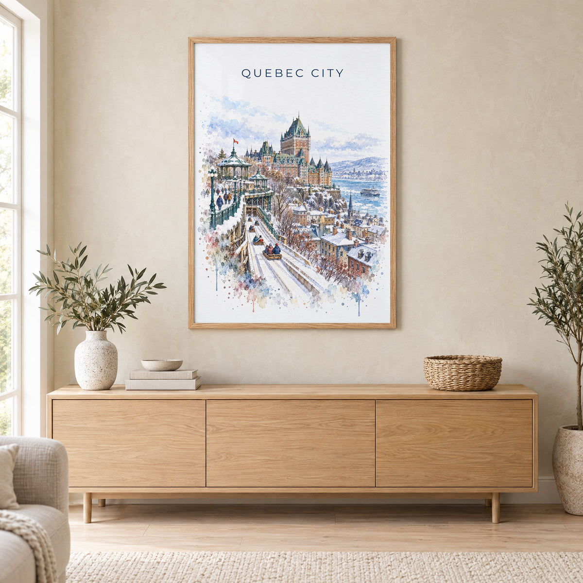 Quebec City watercolor print in an oak frame above a light wood sideboard in a Scandinavian living room