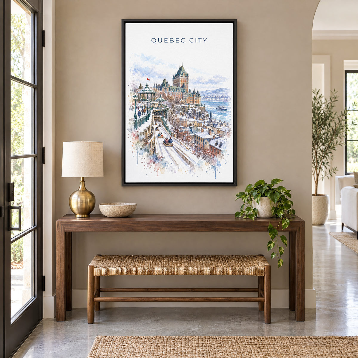Quebec City watercolor print as a black floater canvas above a walnut console and woven bench in an entryway