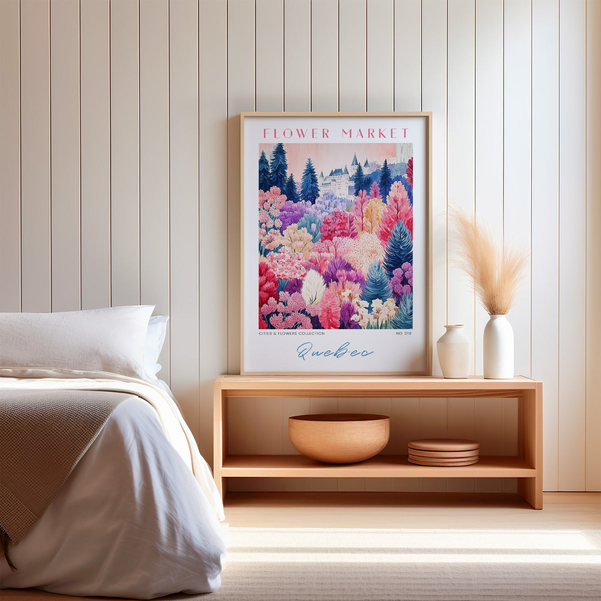 Quebec flower market print in an oak frame on a wood bench against a white shiplap bedroom wall with pampas grass