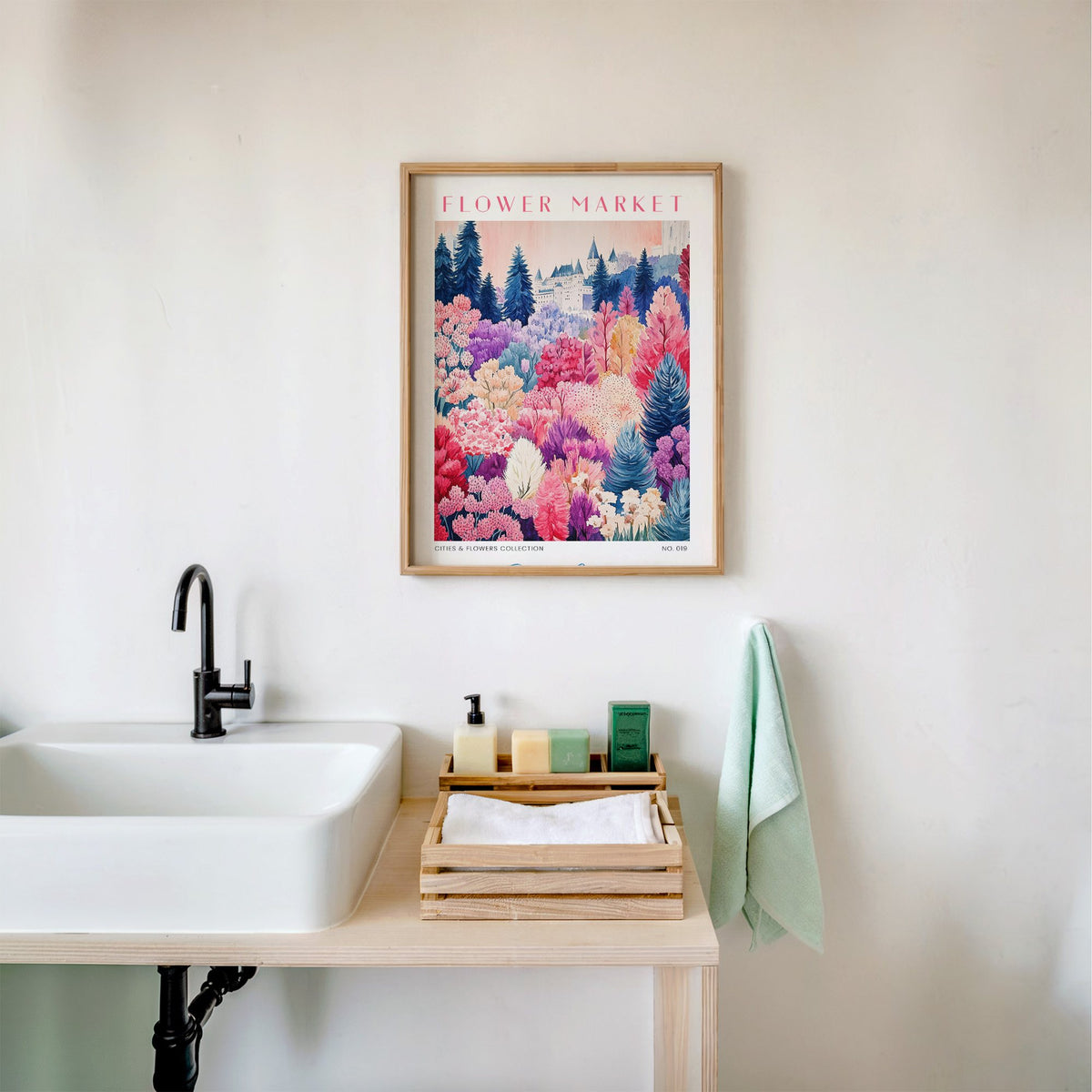 Quebec flower market print in an oak frame above a white bathroom sink with folded towels