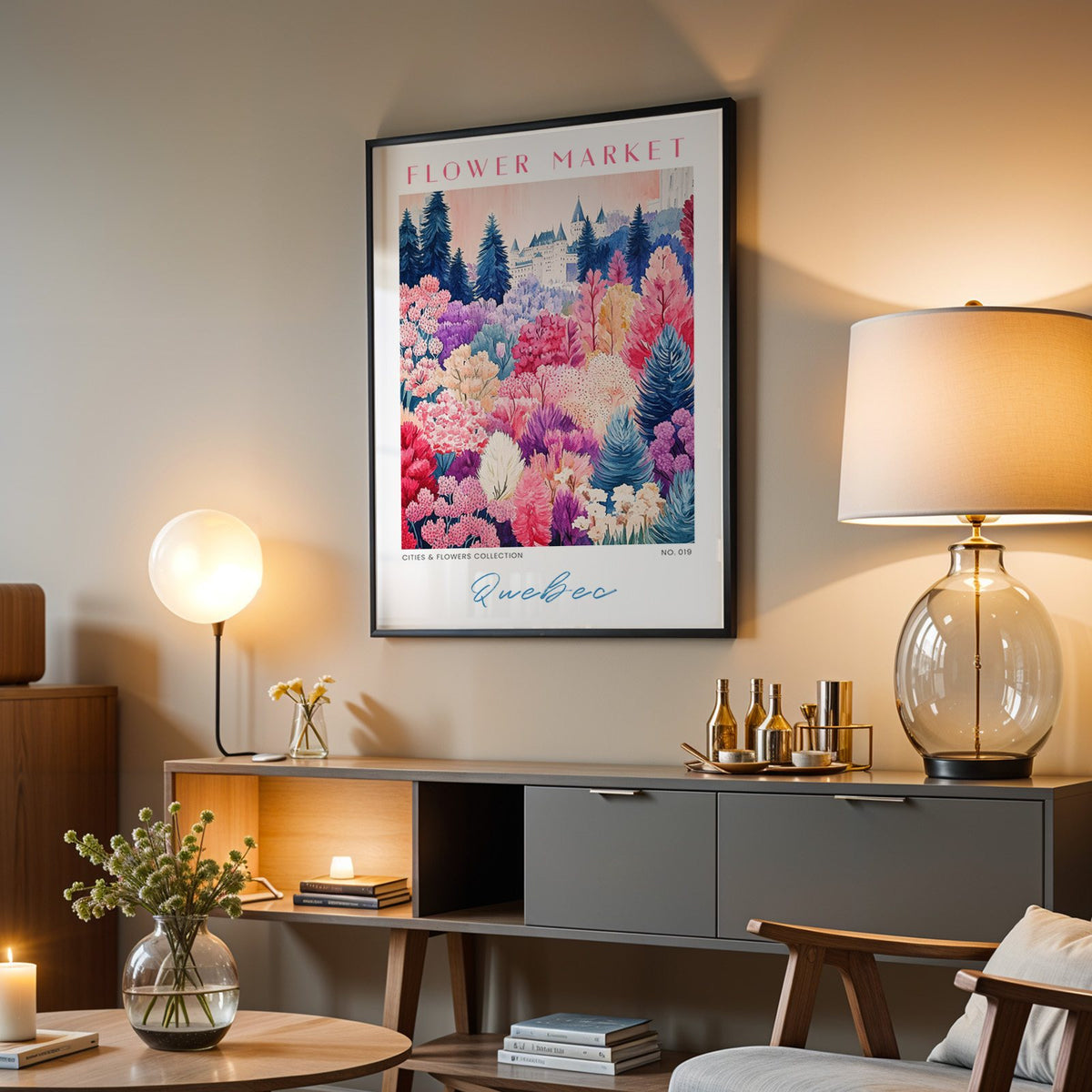 Quebec flower market print in a black frame above a grey media console with a glass table lamp