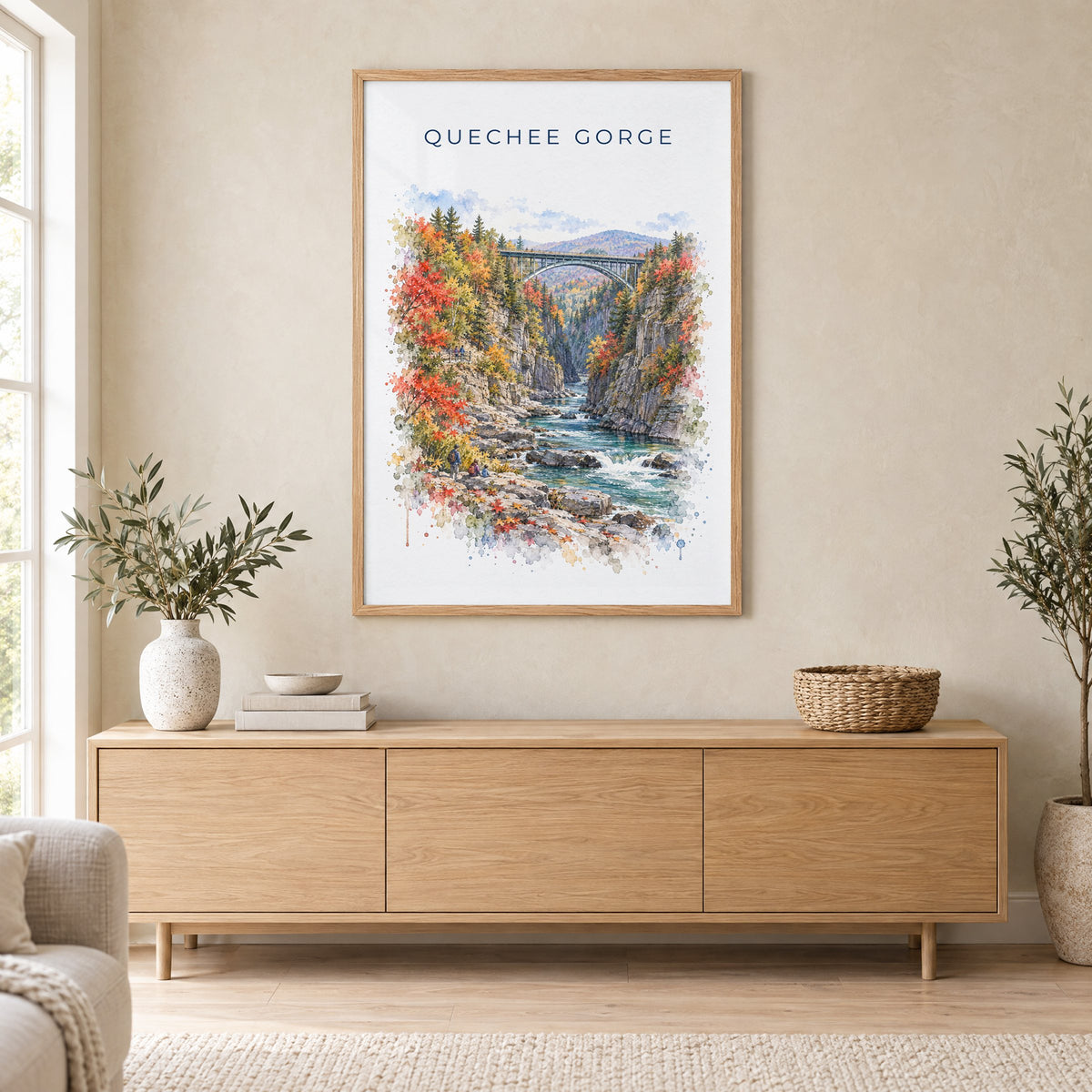 Quechee Gorge watercolor print in an oak frame above a light wood sideboard in a Scandinavian living room