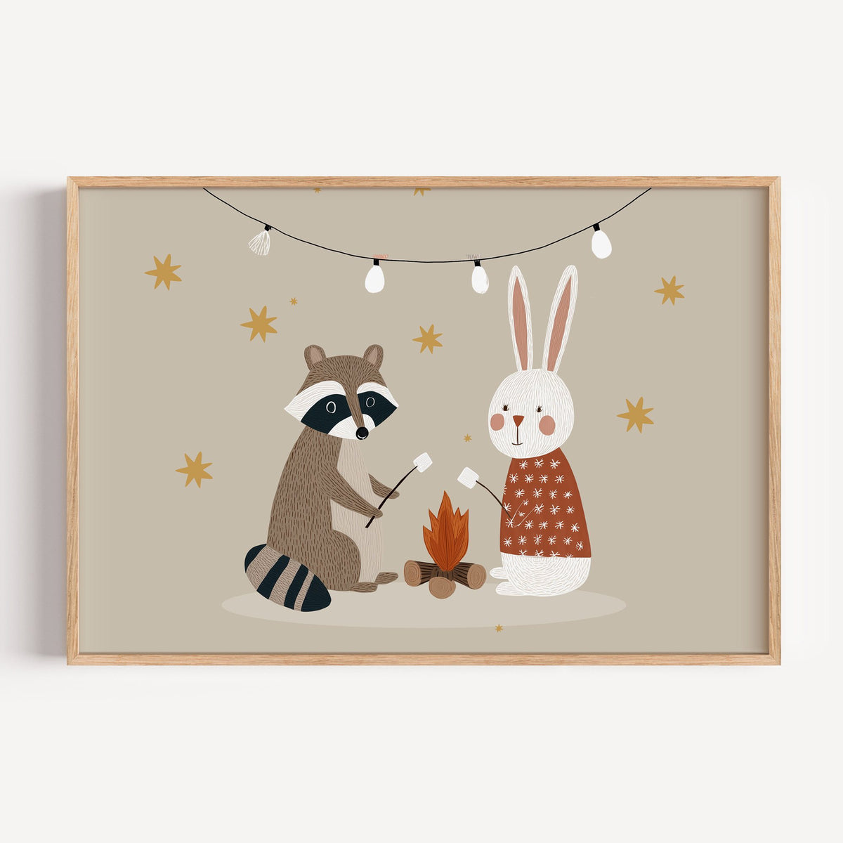 Landscape raccoon and bunny campfire nursery print in a light oak frame on a plain white wall