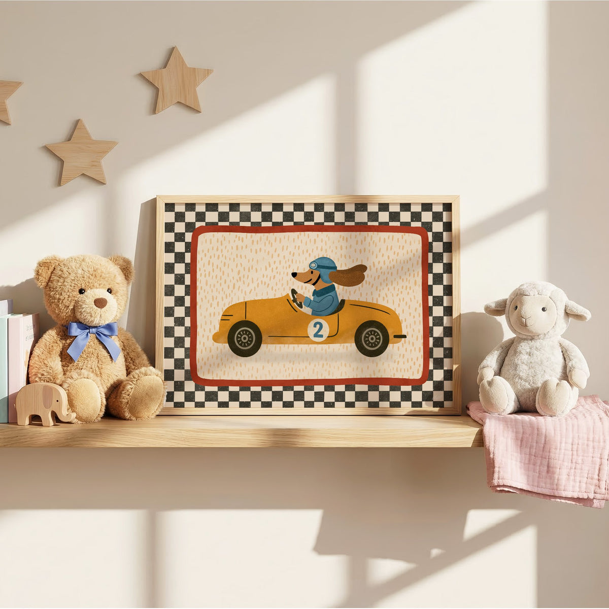 Dog driving yellow race car nursery print in an oak frame on a wall shelf between a teddy bear and a toy lamb