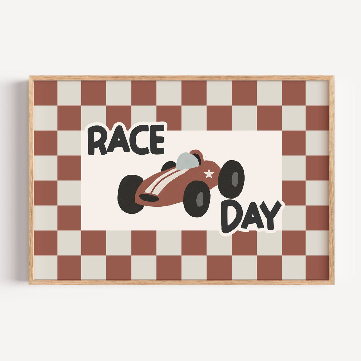 Landscape race day red checkered nursery print in a light oak frame on a plain white wall