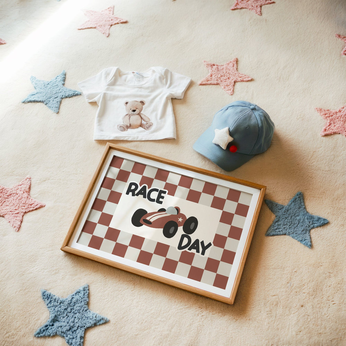 Landscape race day red checkered nursery print in a matted oak frame on a star rug with a baby tee