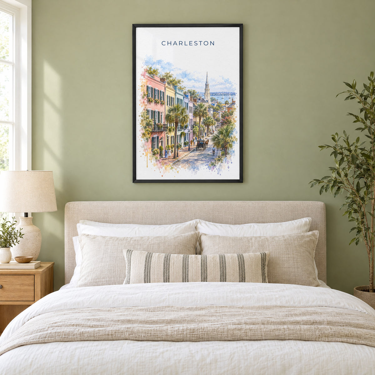 Rainbow Row Charleston watercolor print in a black frame above an upholstered headboard in a sage green bedroom