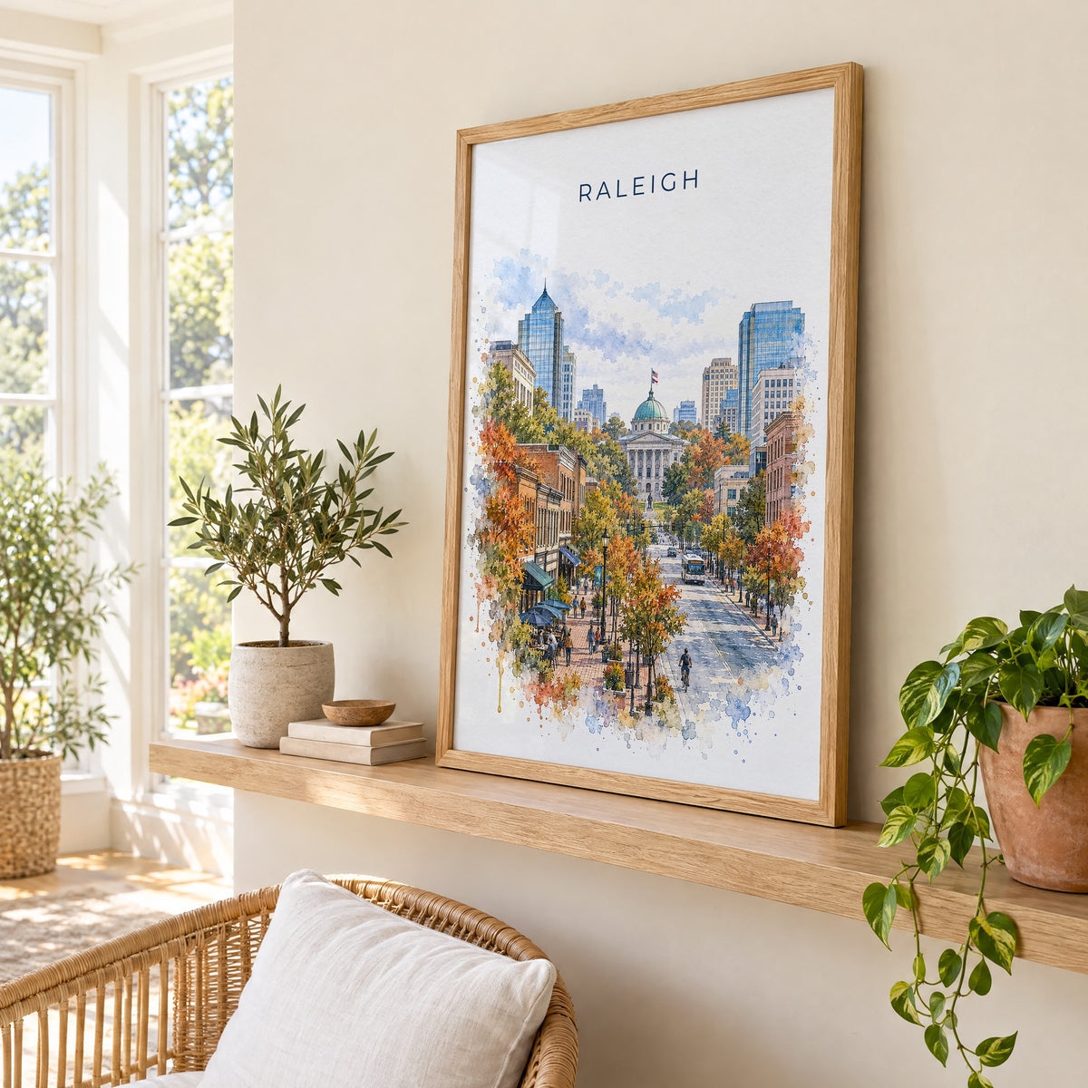 Raleigh watercolor print in an oak frame on a picture ledge in a sunlit sunroom
