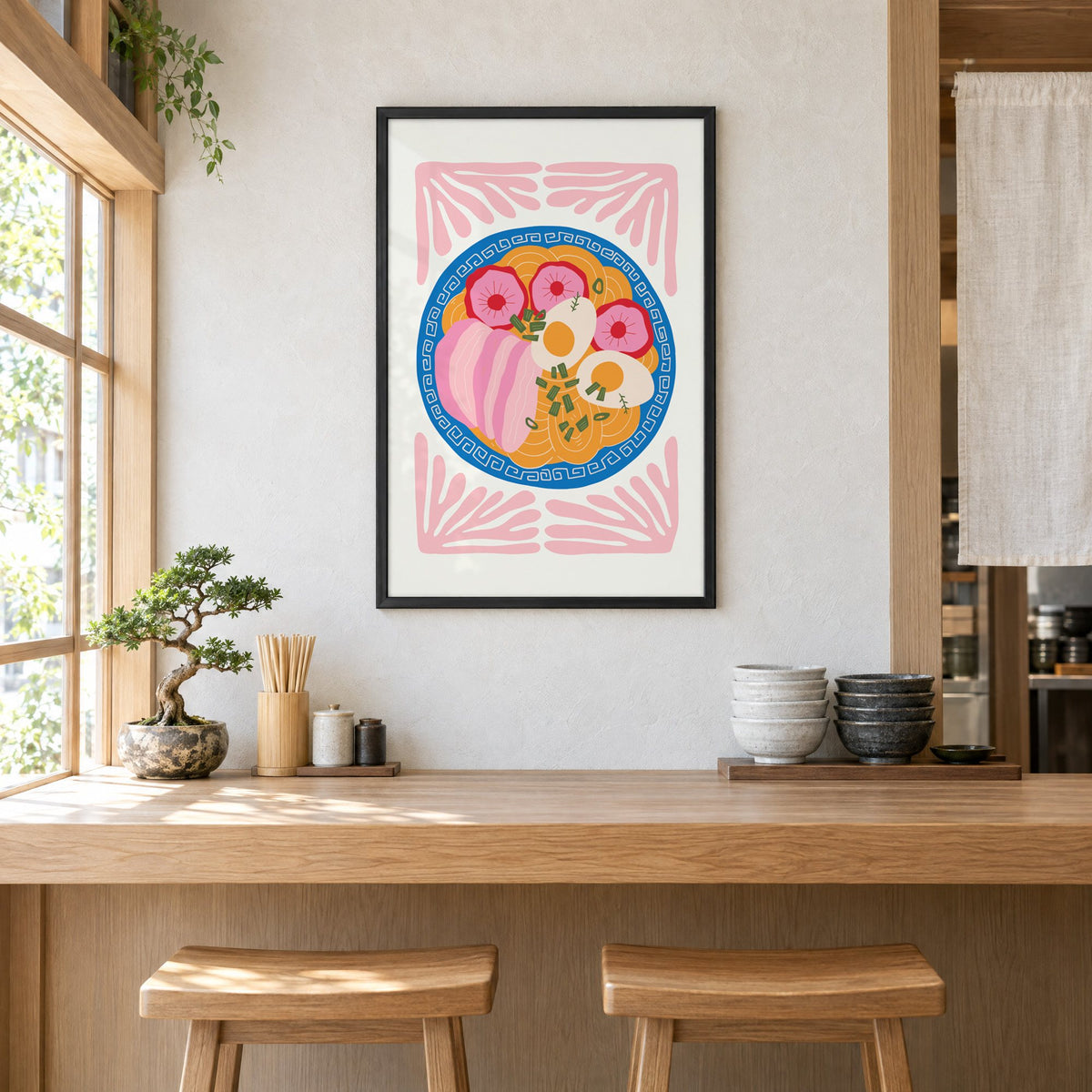ramen bowl top view pink leaf frame print in a black frame above a light wood ramen counter with stools and stacked bowls