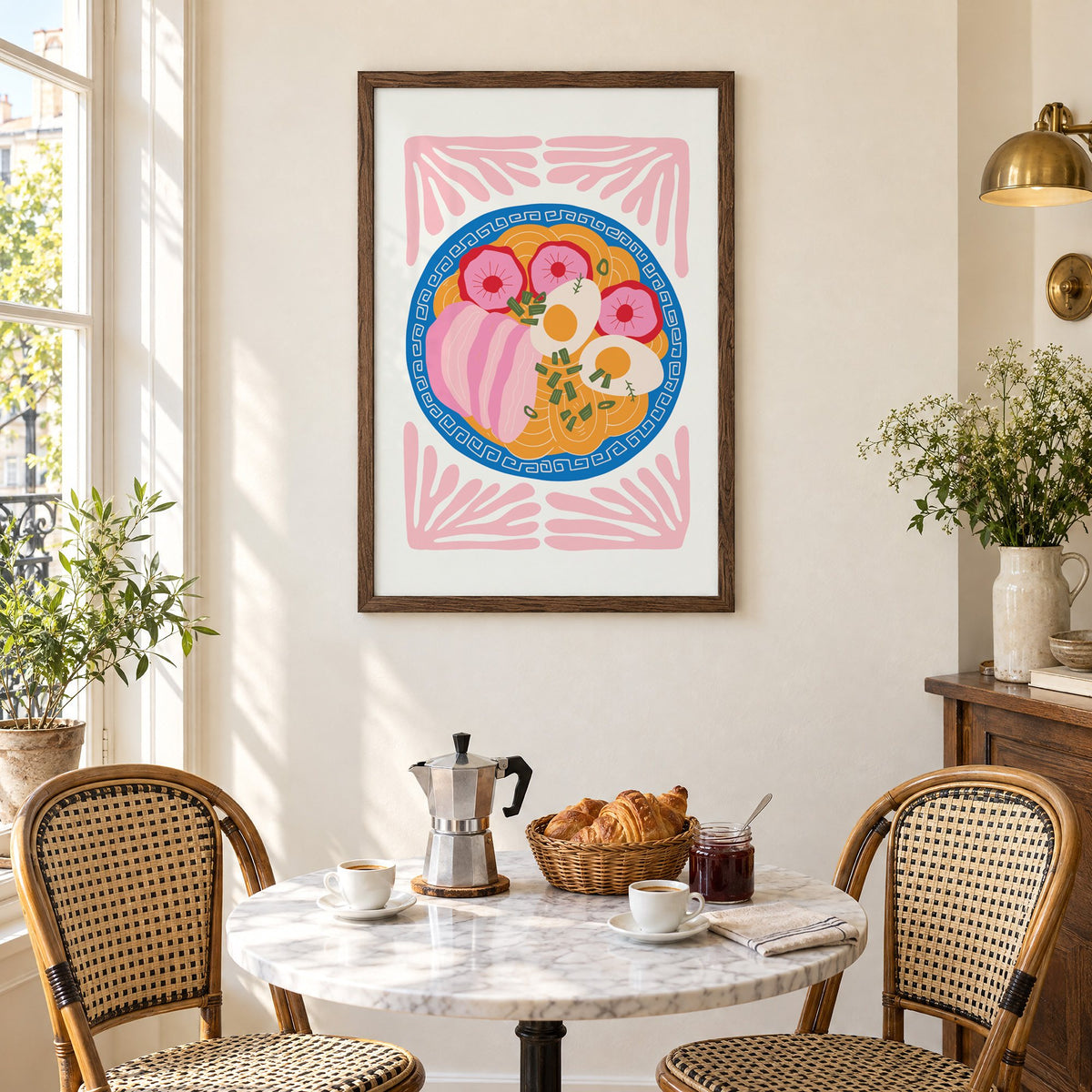 ramen bowl top view pink leaf frame print in a walnut frame above a marble bistro table with croissants and rattan chairs
