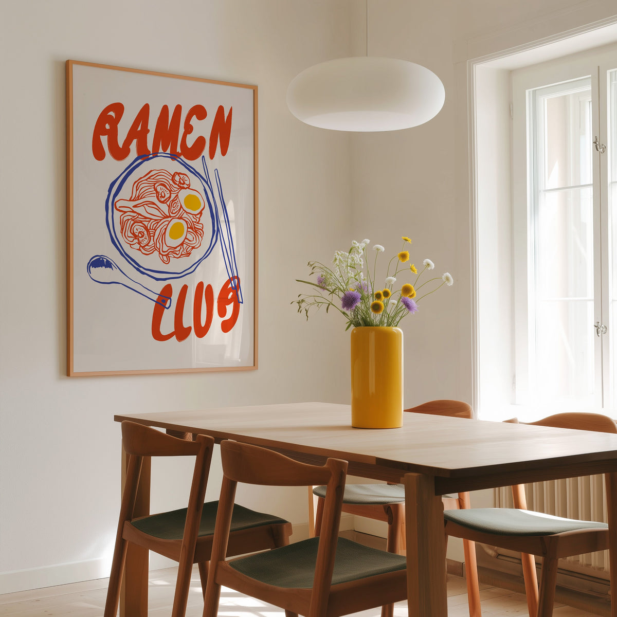 Ramen Club red and blue print in a slim oak frame above a dining table