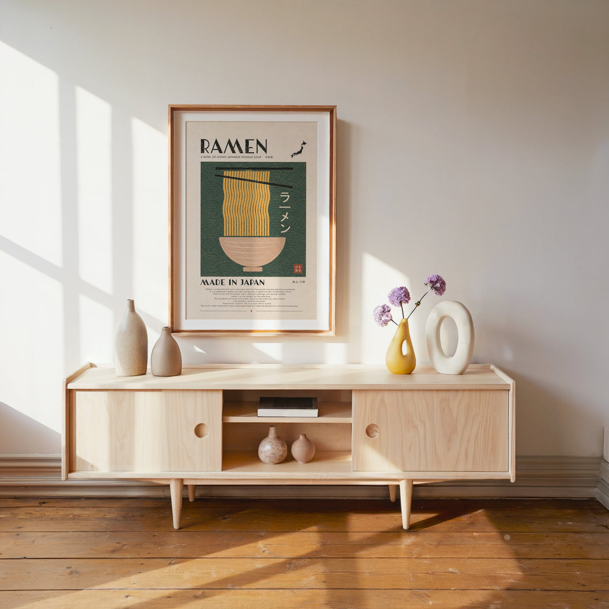 ramen noodles on green wave panel print shown in a wood frame with a white mat above a pale wood media console