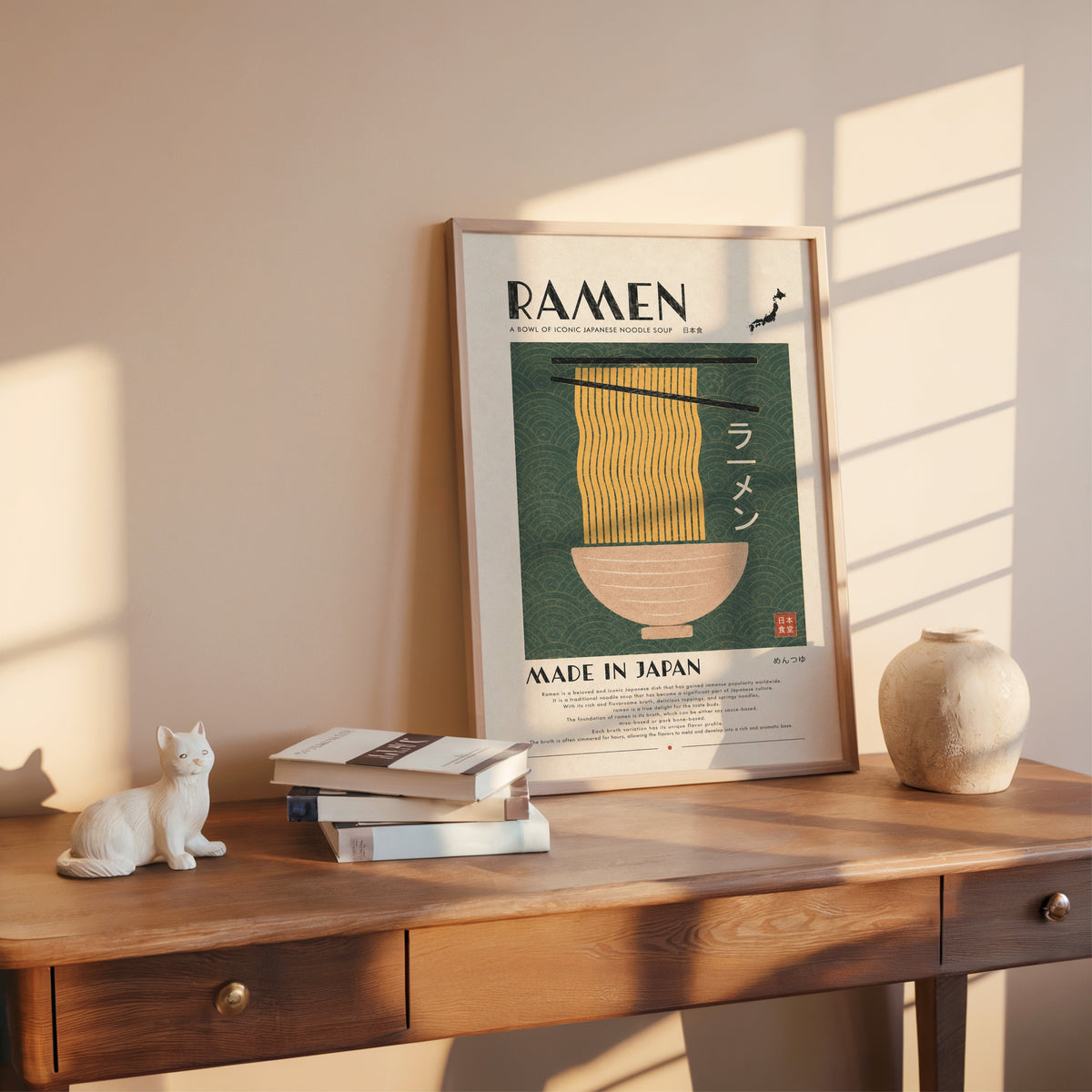 ramen noodles on green wave panel print shown in a rose gold frame leaning on a wooden writing desk with books