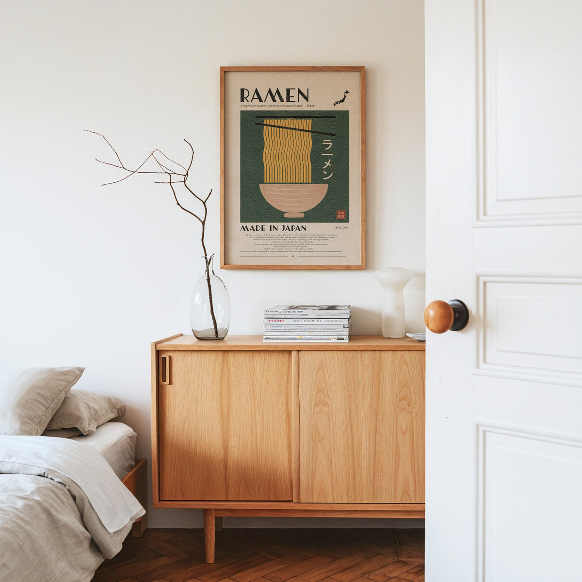ramen noodles on green wave panel print in an oak frame above an oak sideboard in a bedroom with linen bedding
