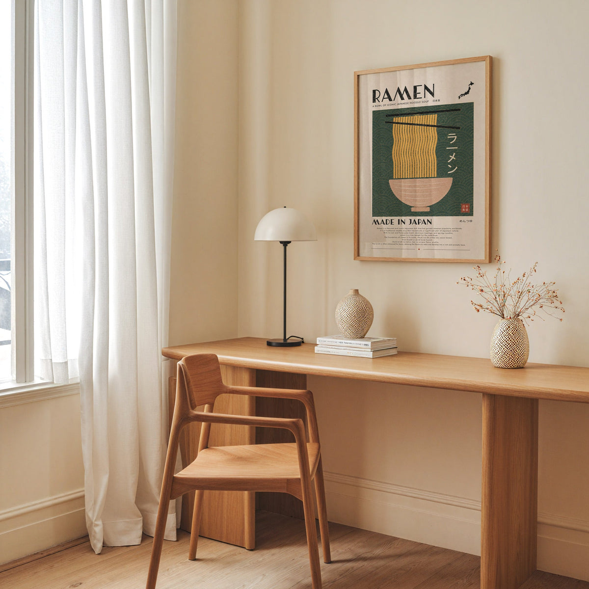 ramen noodles on green wave panel print in an oak frame above a long oak desk with a white dome lamp and woven vases