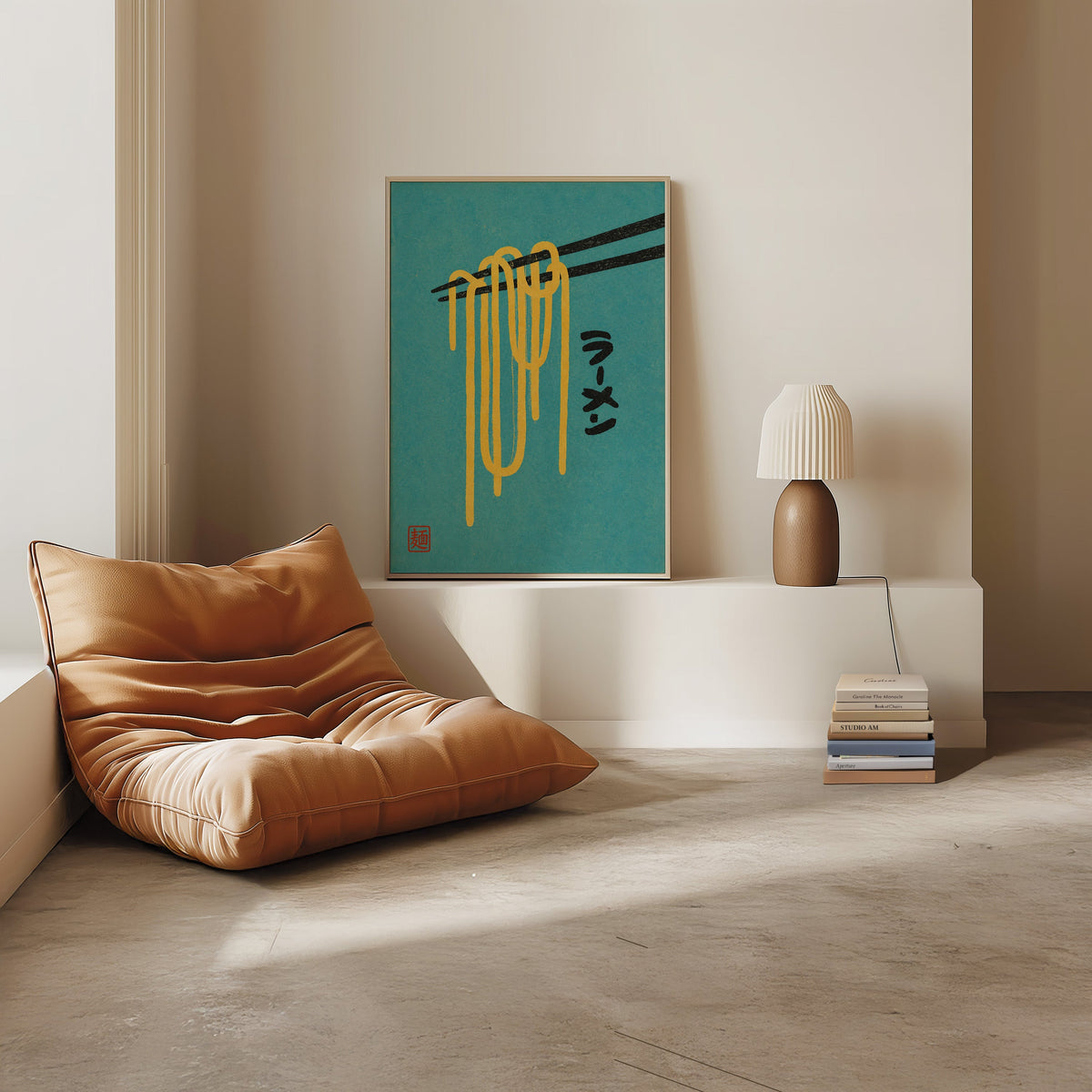 ramen noodles and chopsticks on teal print in a light oak frame on a white ledge by a tan leather floor chair