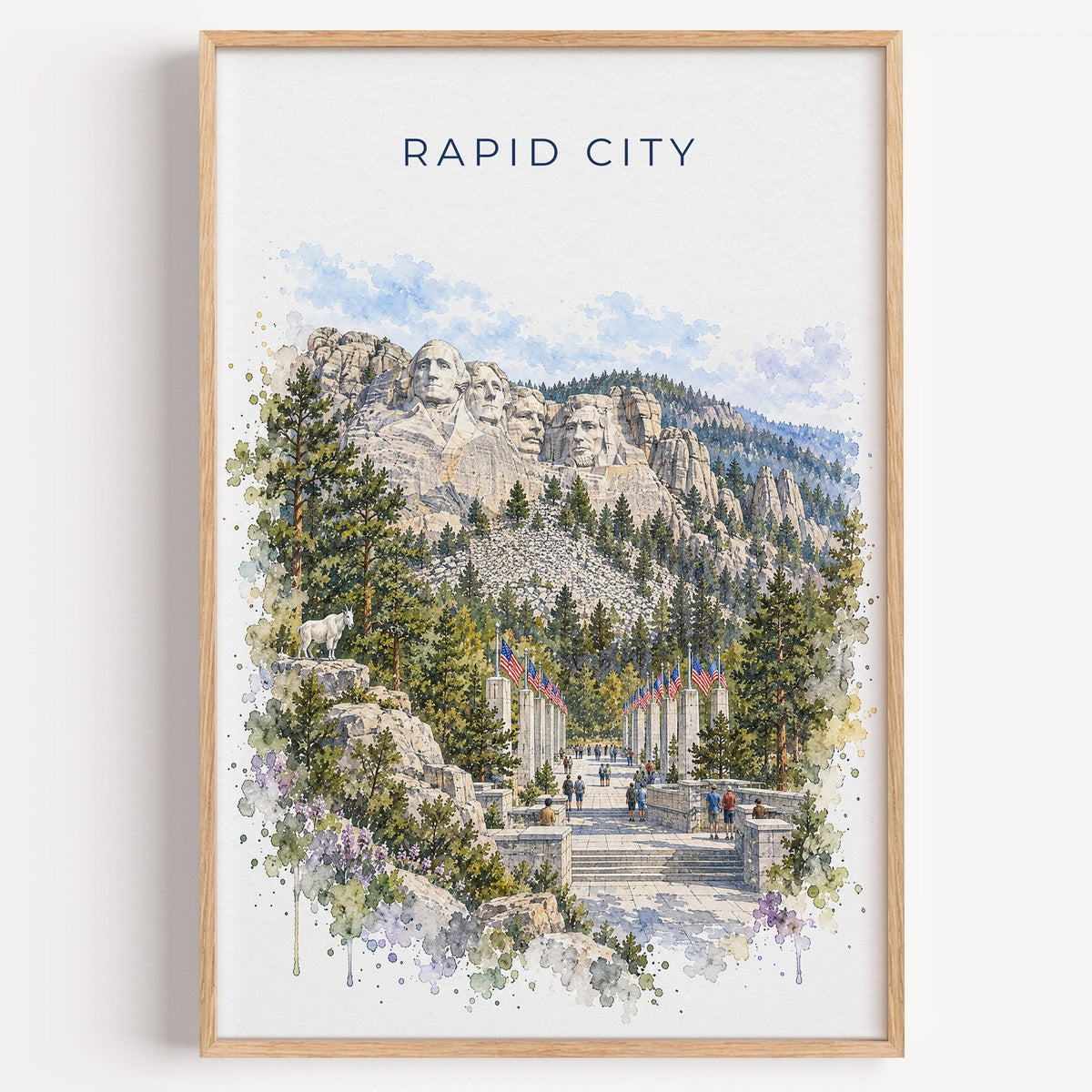 Rapid City watercolor print in a light oak frame on a plain white wall