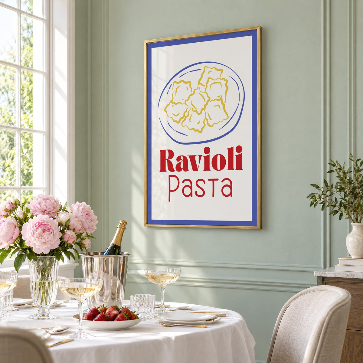 Ravioli Pasta red title ravioli plate print in a brass frame on a sage wall above a brunch table with champagne and peonies, seen at an angle