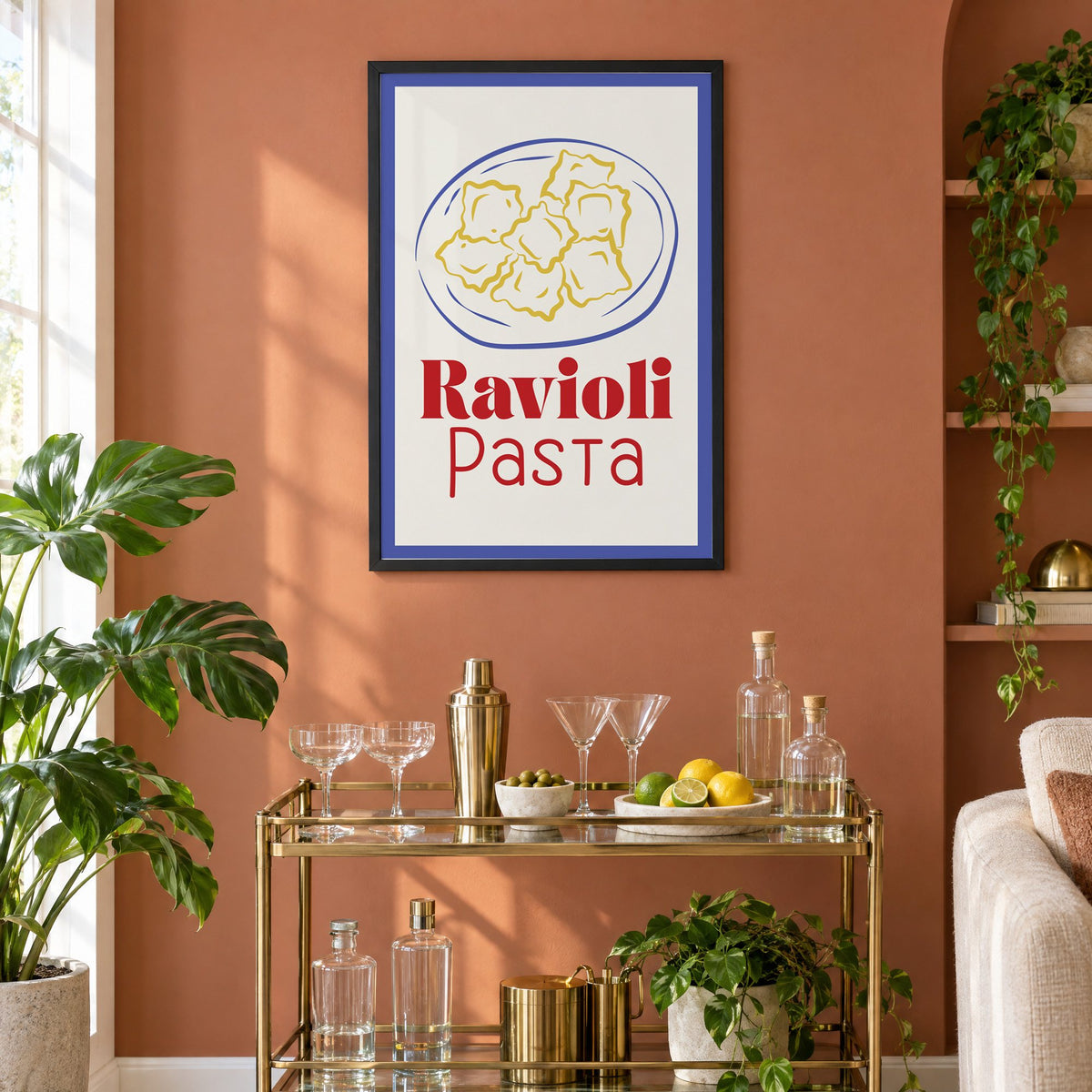 Ravioli Pasta red title ravioli plate print in a black frame on a terracotta wall above a brass bar cart with coupes and citrus