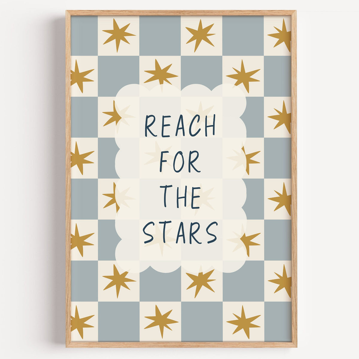 Reach for the stars cloud nursery print in a light oak frame on a plain white wall