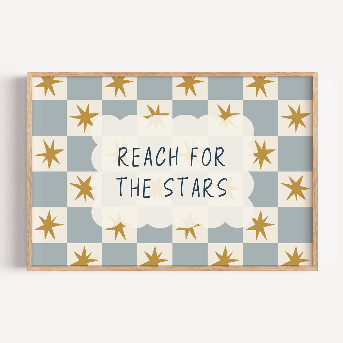 Landscape reach for the stars cloud nursery print in a light oak frame on a plain white wall