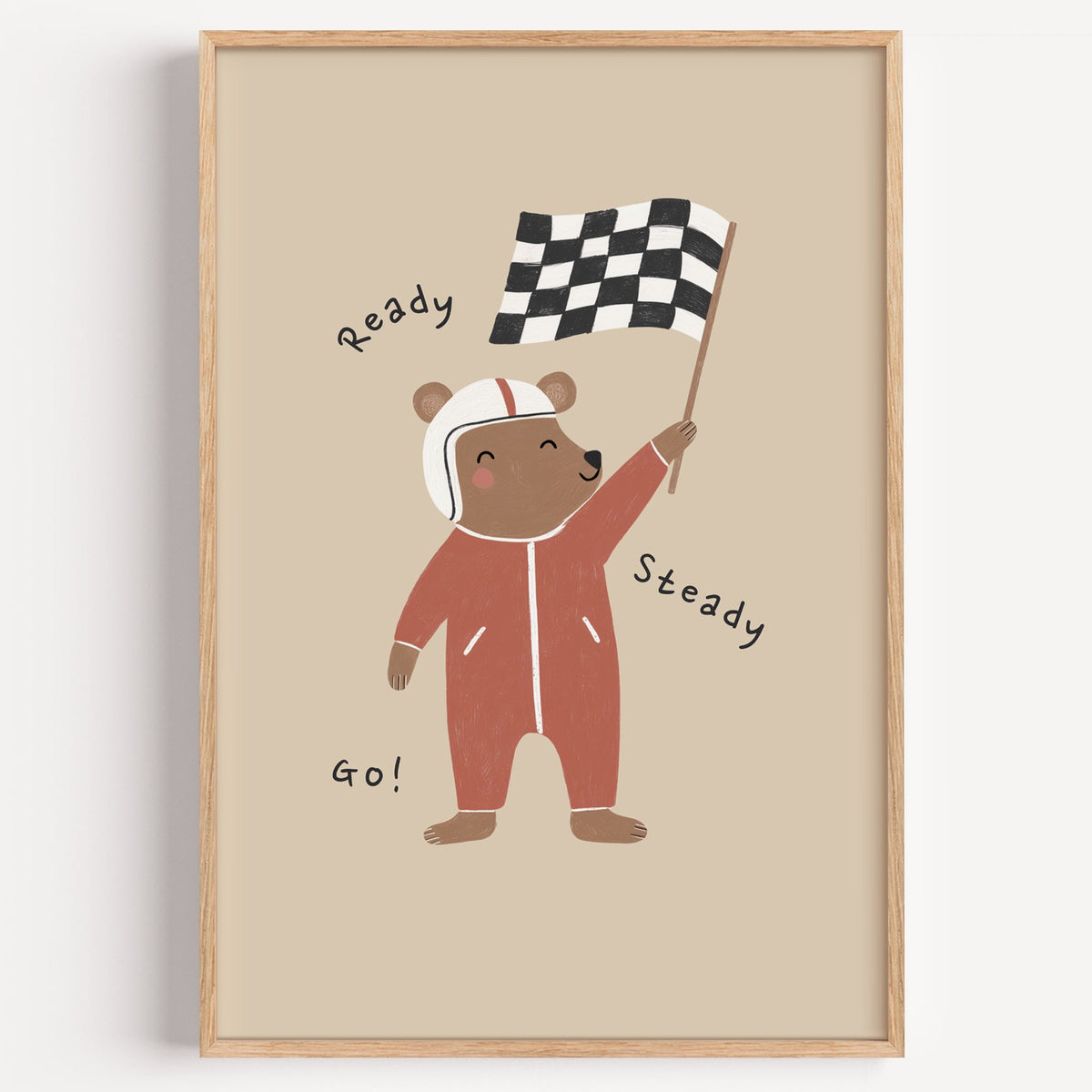 Ready steady go racing bear nursery print in a light oak frame on a plain white wall