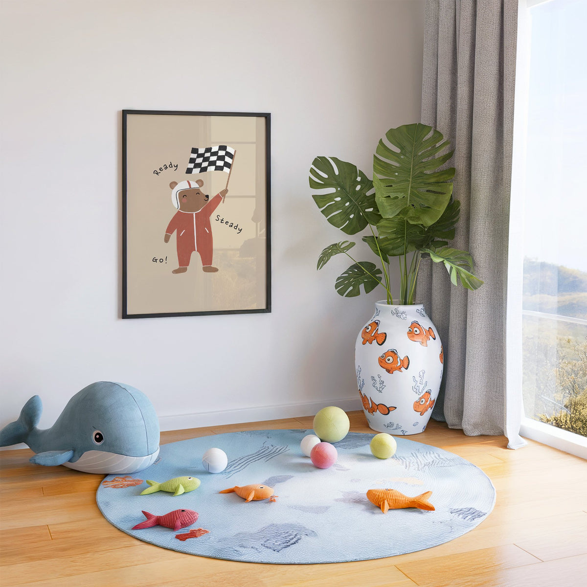 Ready steady go racing bear nursery print in a black frame in a playroom with an ocean rug and whale plush
