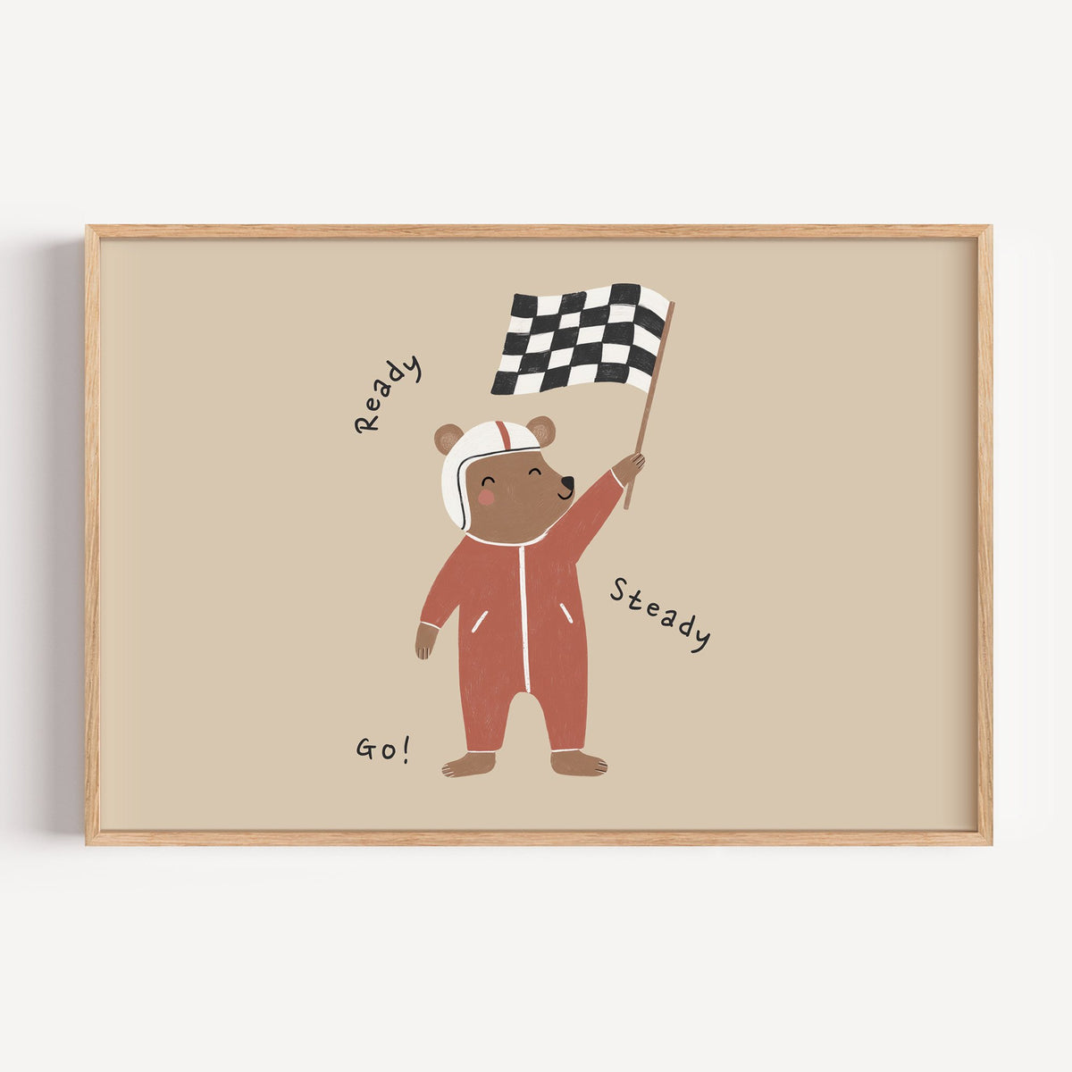 Landscape ready steady go racing bear nursery print in a light oak frame on a plain white wall