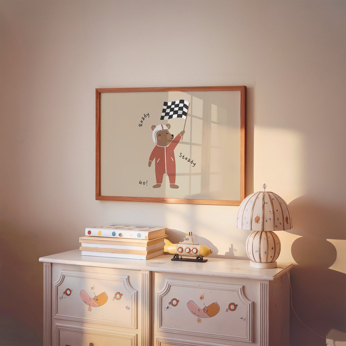 Landscape ready steady go racing bear nursery print in a cherry wood frame above a painted dresser and lamp