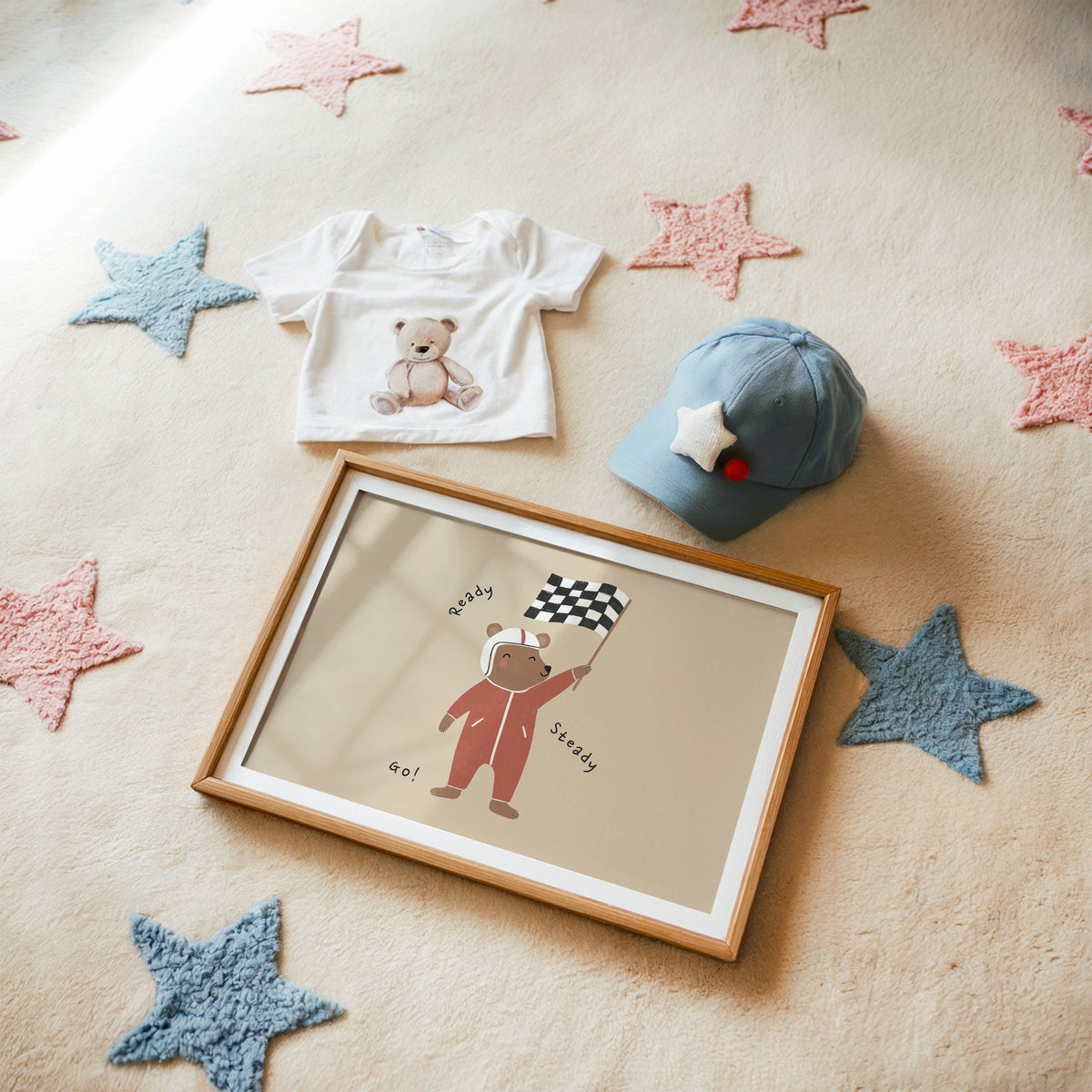Landscape ready steady go racing bear nursery print in a matted oak frame on a star rug with a baby tee