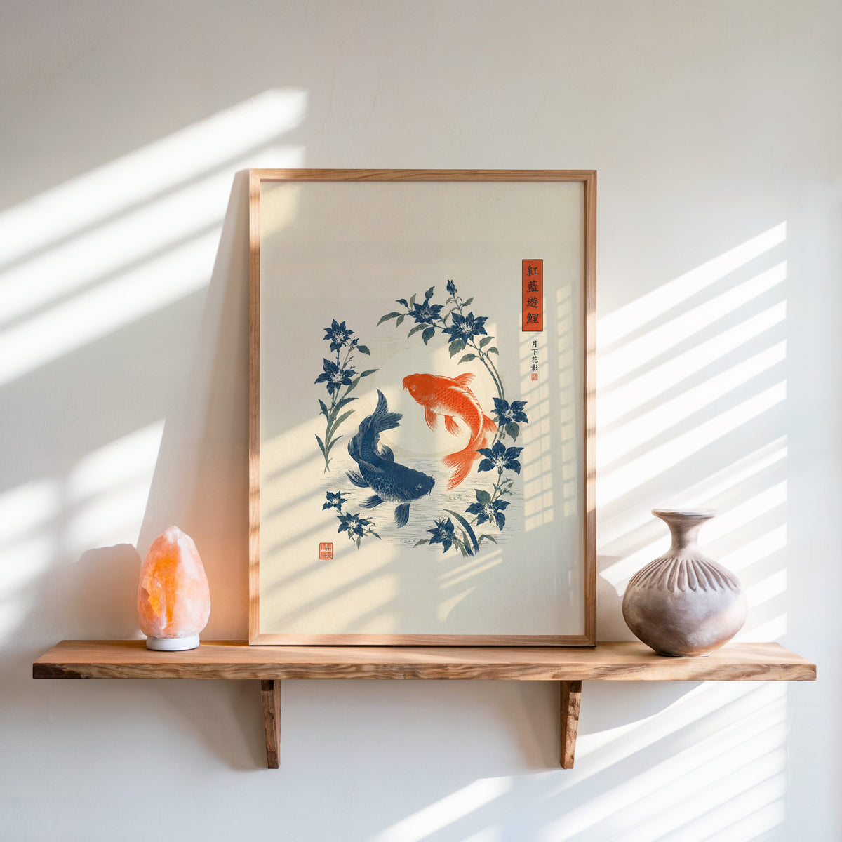 red and blue koi with blue flowers print in an oak frame on a live-edge wall shelf with a salt lamp and clay vase