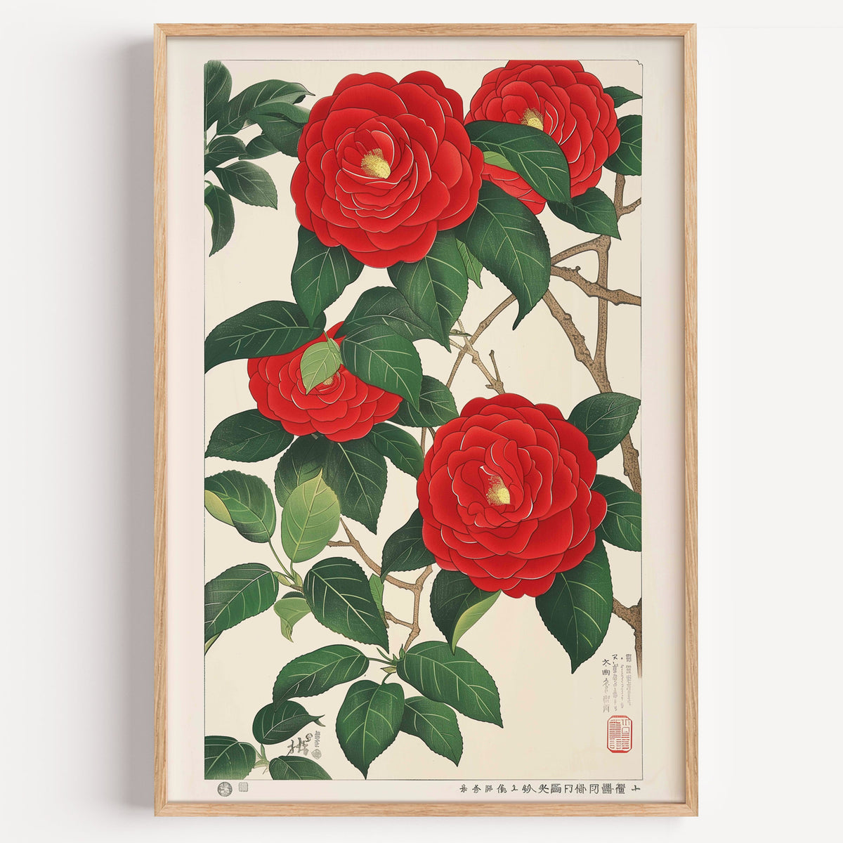 Red camellia woodblock-style print in a light oak frame on a plain white wall