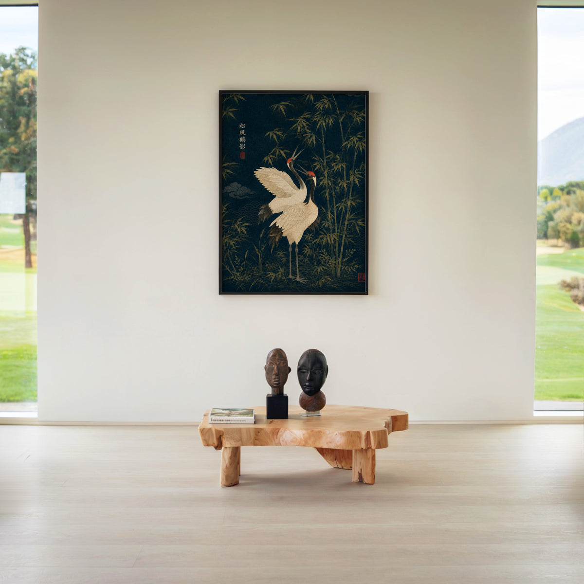 red-crowned cranes and bamboo on navy print in a black frame above a live-edge wood coffee table between garden windows