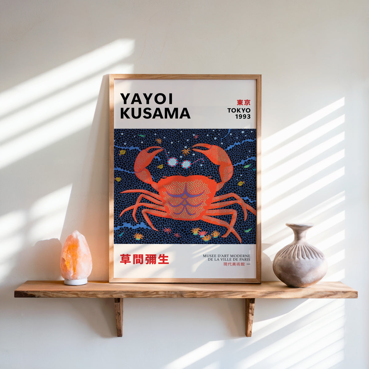 Yayoi Kusama inspired red dotted crab print above a shelf with a salt lamp