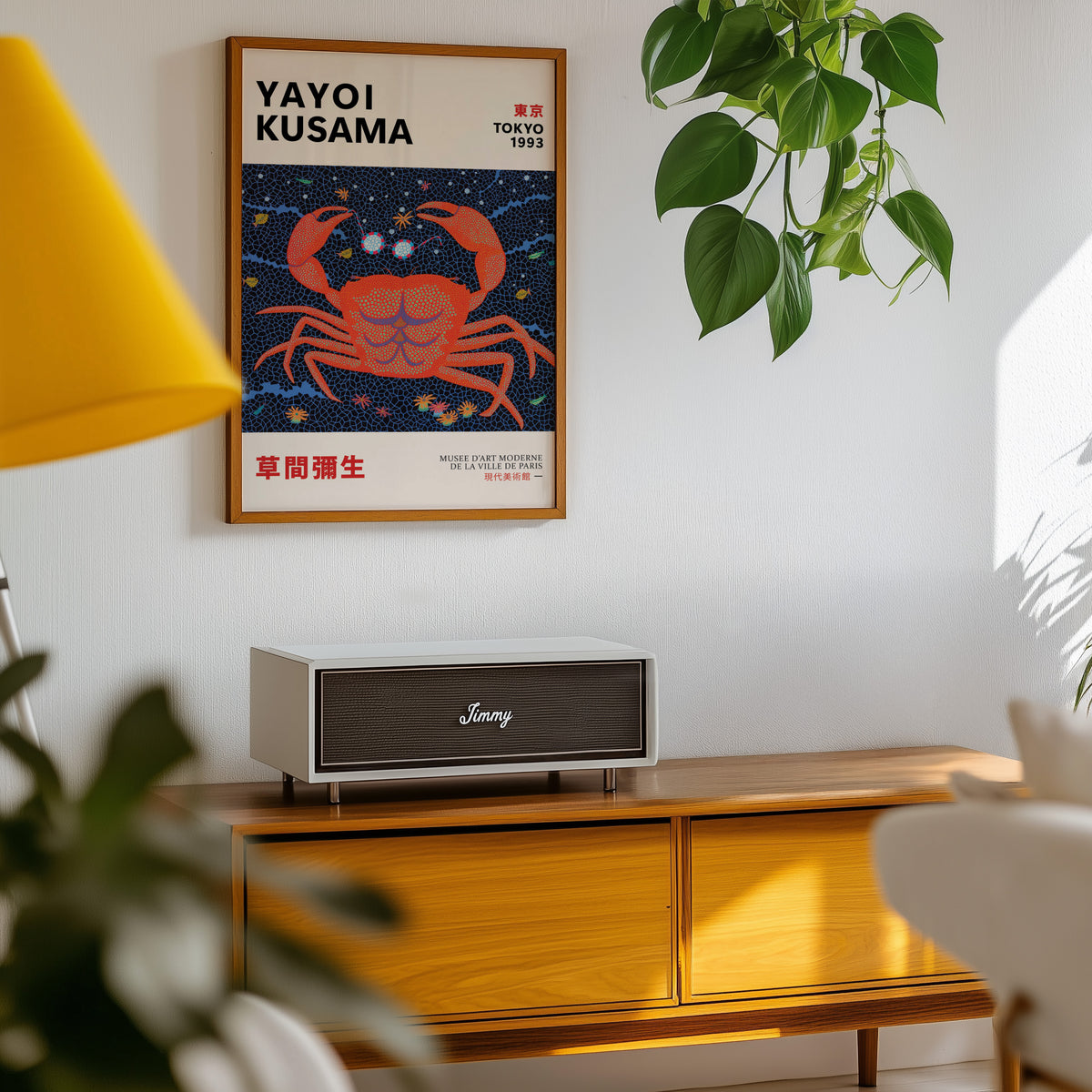 Yayoi Kusama inspired red dotted crab print above a sideboard with a plant