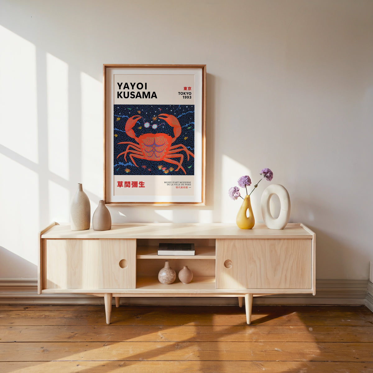 Yayoi Kusama inspired red dotted crab print above a pale wood console