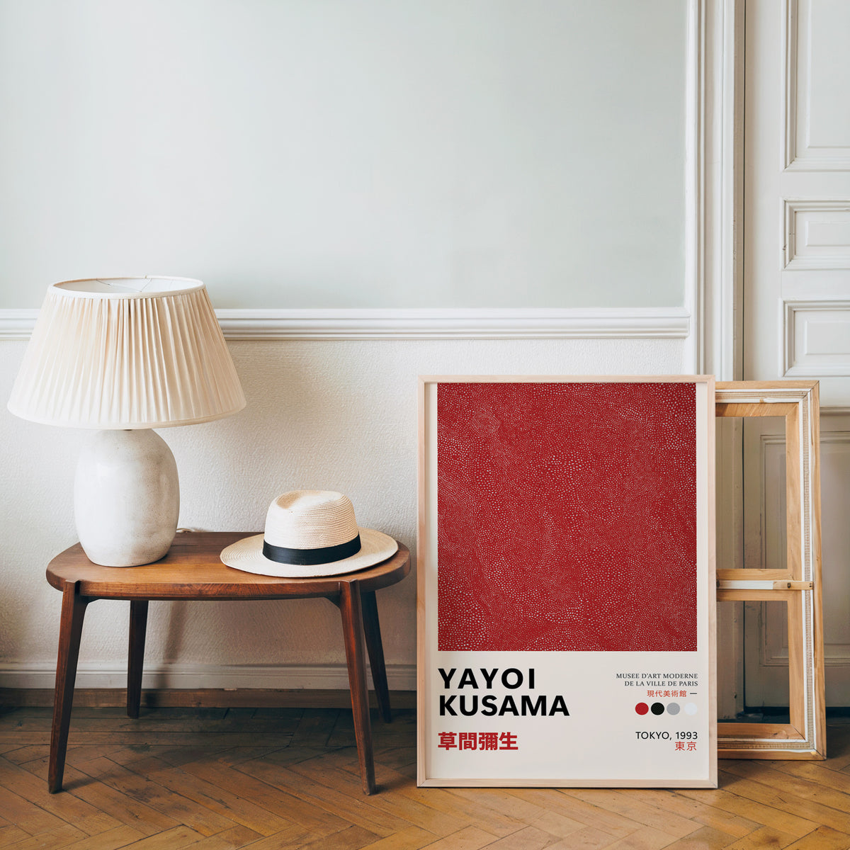Yayoi Kusama inspired red dotted texture print beside a bench and straw hat