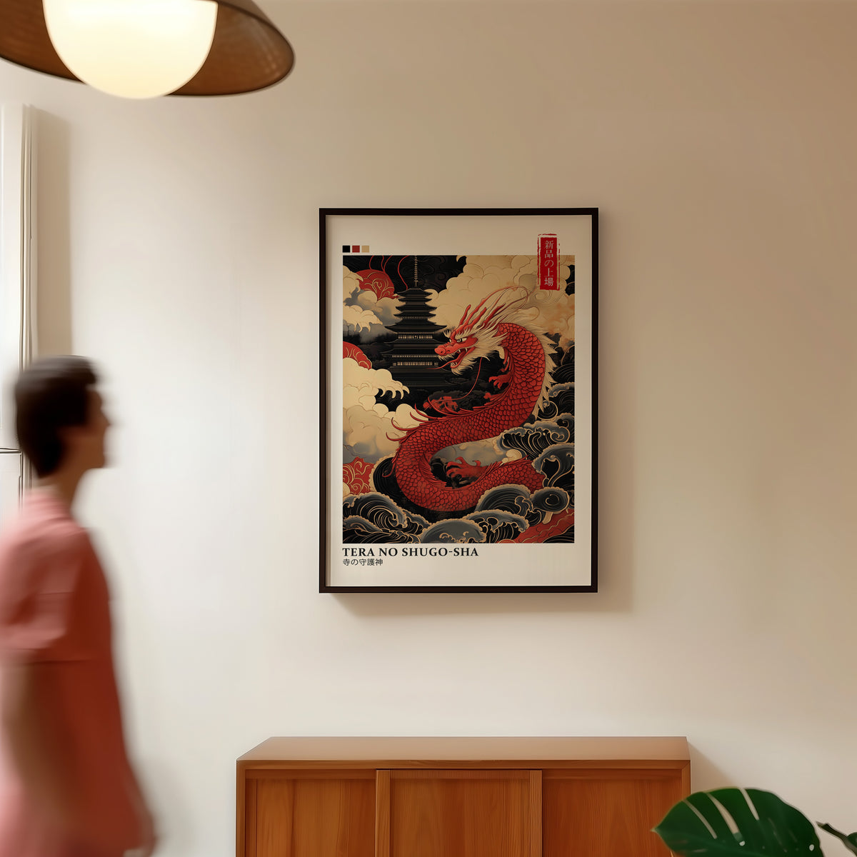 Red dragon guarding black pagoda print in a black frame in a hallway under a rattan pendant