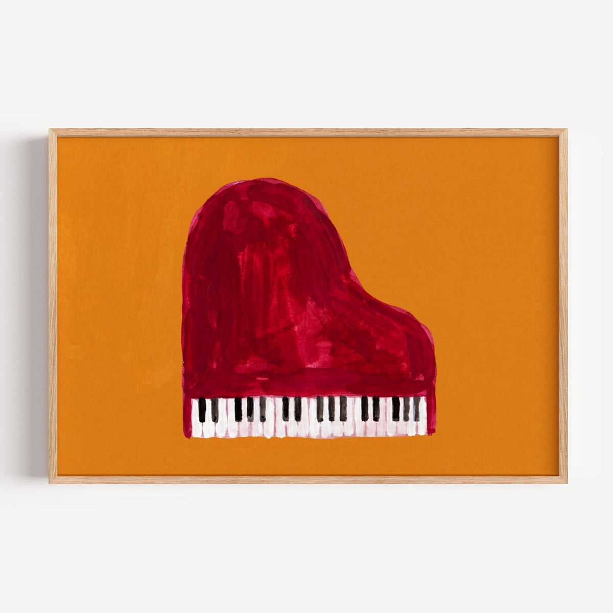 Red grand piano print in a light oak frame on a plain white wall